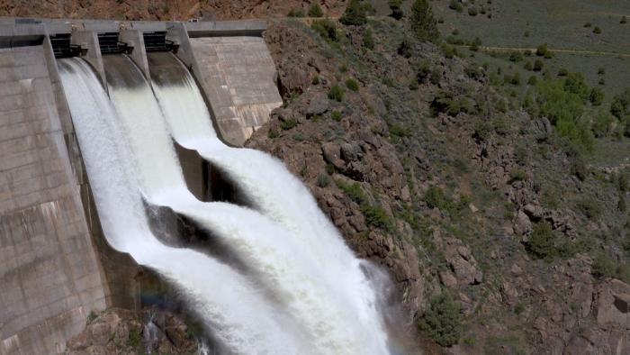 Water spills down the face of a dam