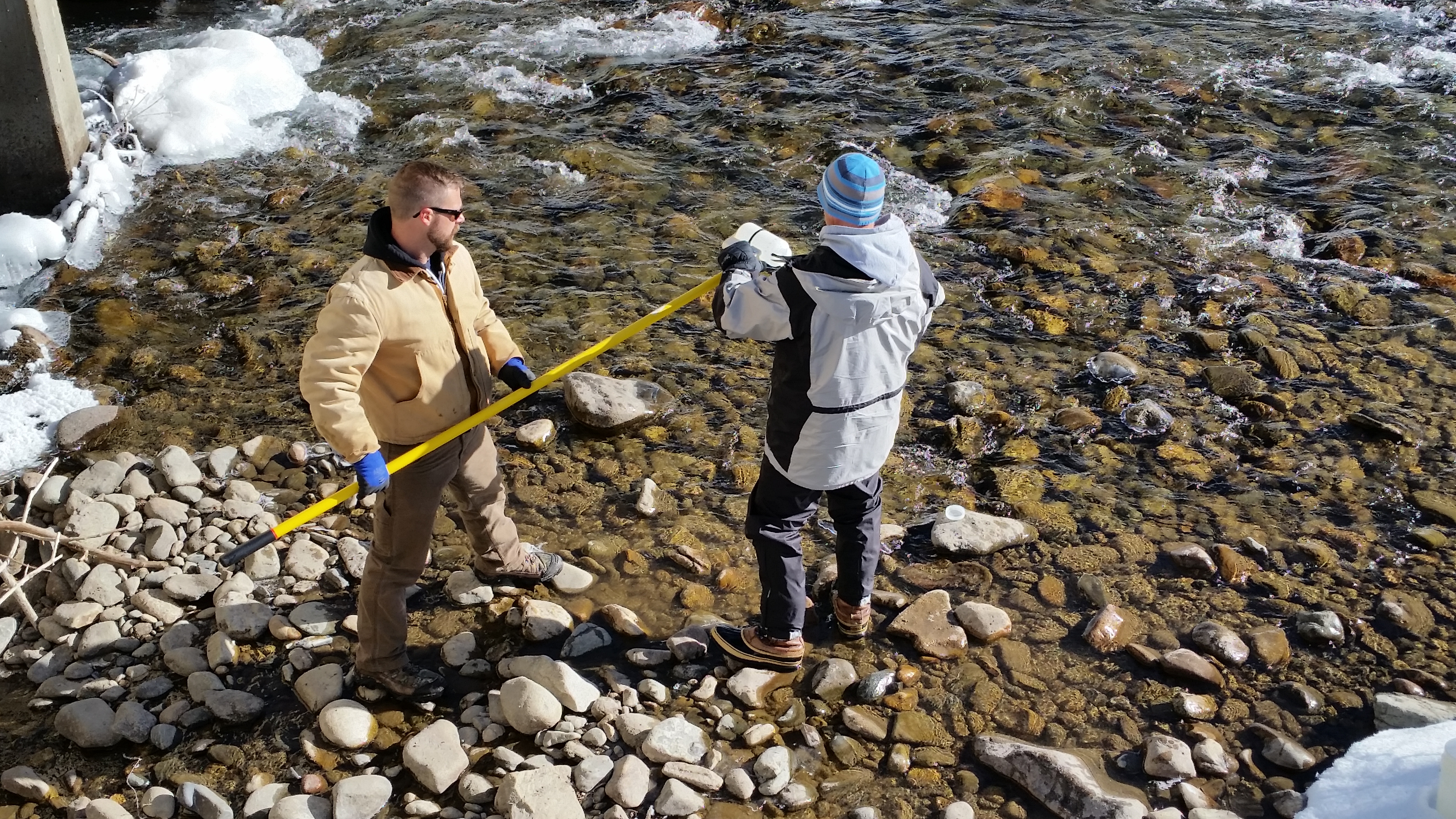 2 Employees sampling water within the Dillon watershed. 