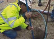 Installing cathodic protection systems onto large pipes involves connecting the pipes to bags of magnesium or zinc with wires.