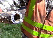 Denver water employee holding lead pipe.