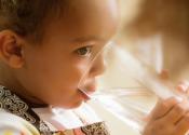 Little girl drinking water.