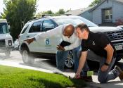 Two Denver Water employees conduct a sprinkler audit