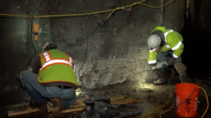 Workers repair section of damaged concrete inside Dillon Dam outlet tunnel