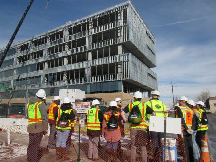 A group of Denver Water employees at the base of the new Administration Building during its construction phase.