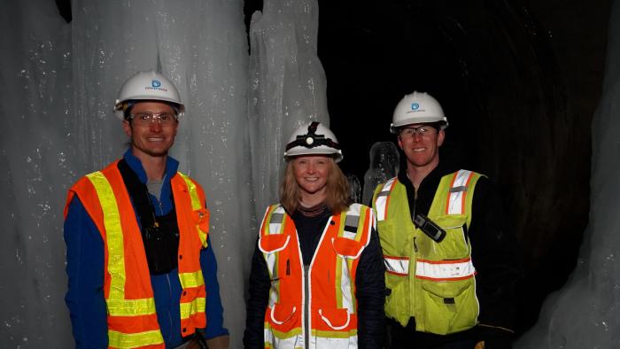 Denver Water team stands next to large ice formations in outlet tunnel underneath Dillon Dam