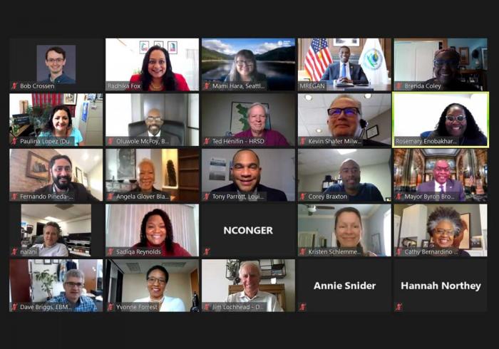 A Zoom screen of people at a virtual meeting.