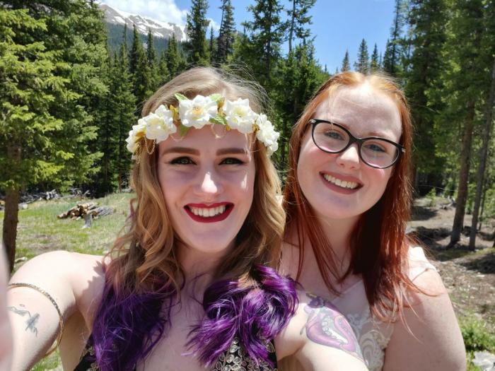Newlyweds Kait (left) and Casey Counter celebrate their marriage after eloping June 14, 2020, at a cabin in the mountains. After canceling their 2020 wedding plans due to the COVID-19 pandemic, the couple kept their elopement a secret until their June 13, 2021, wedding celebration, when they revealed to friends and family, they were actually celebrating their one-year anniversary. Photo credit: Kait Counter.