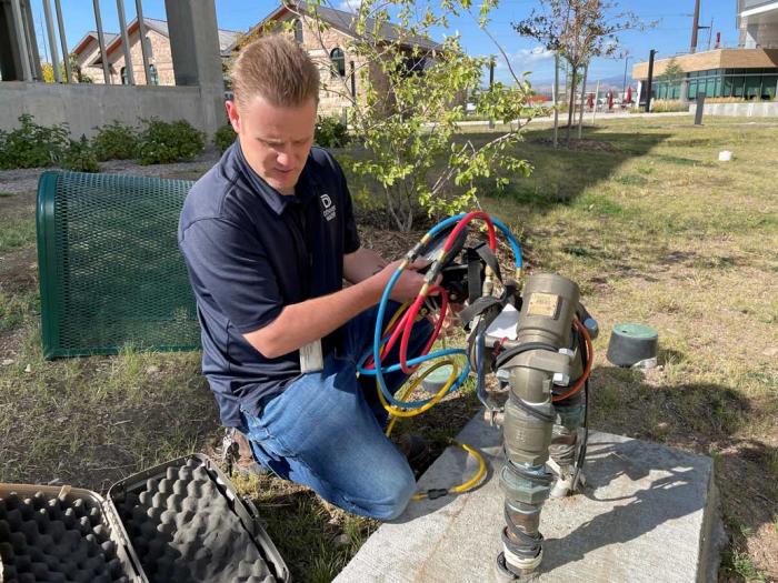 Technician tests backflow prevention device 