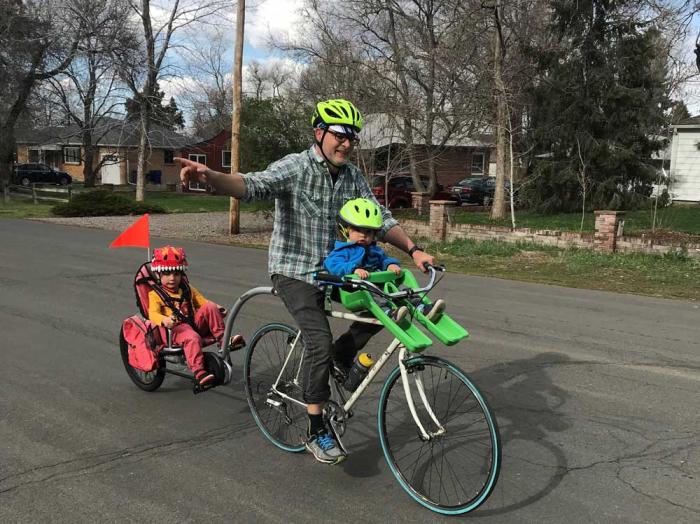 Man and two kids on a bike