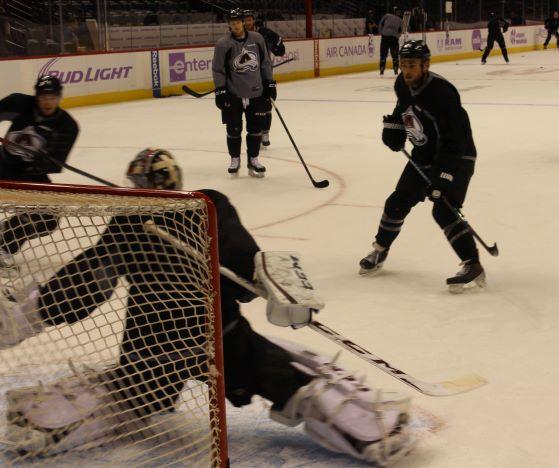 A hockey goalie saves a shot on goal during a practice session.