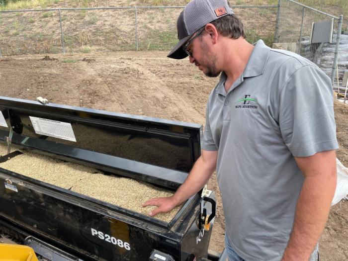 Man looks at grass seed