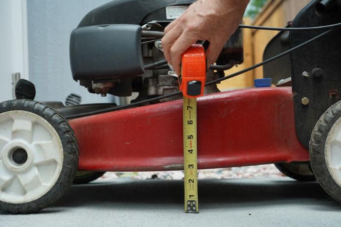 Tape measure next to a lawn mower