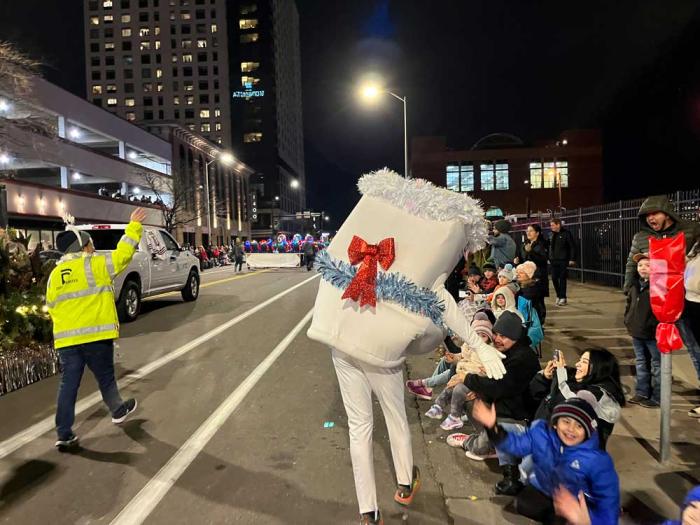 Running Toilet gives a high five to children lining the parade route.