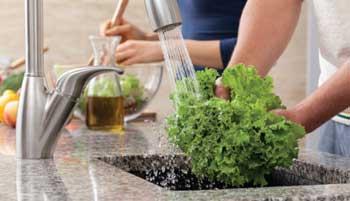Rinsing vegetables in kitchen sink