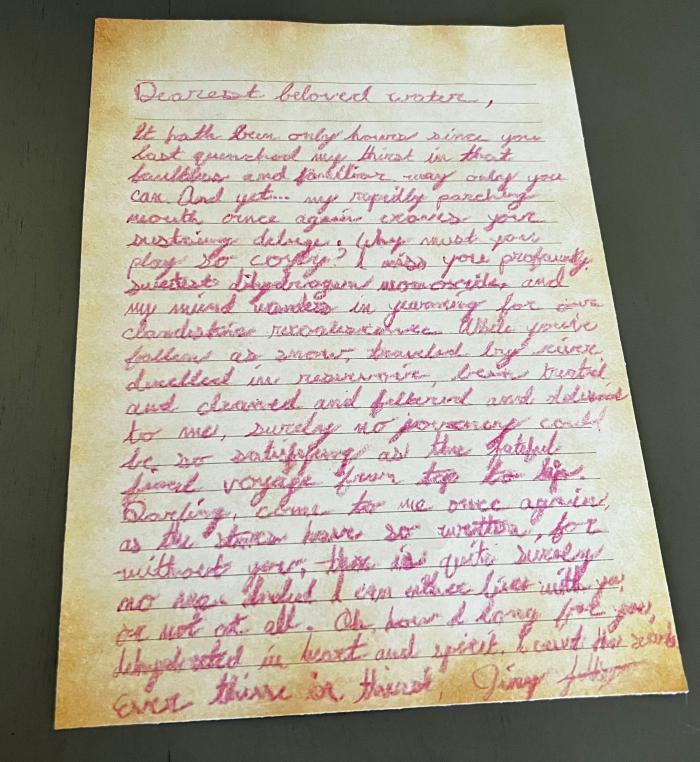 handwritten love letter to water in parchment paper and pink crayon.
