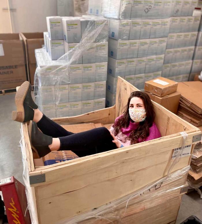 Woman poses in a crate