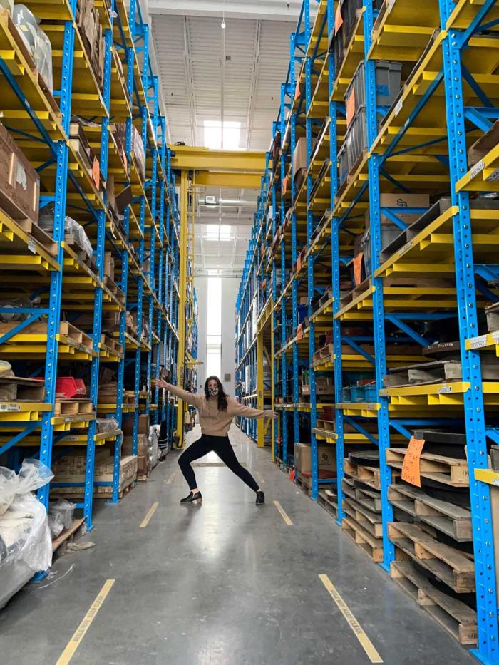 Woman poses in a warehouse