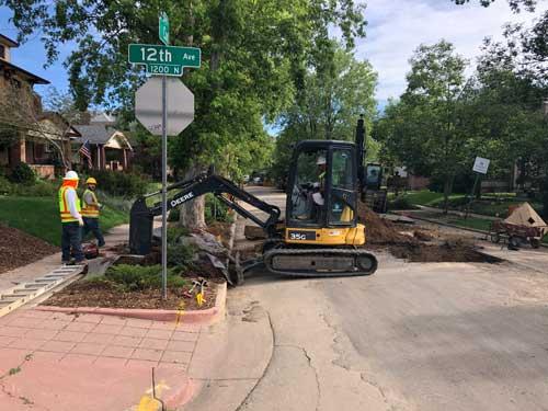 Denver Water crews dig up portions of street and a customer's yard to begin lead service line replacement.