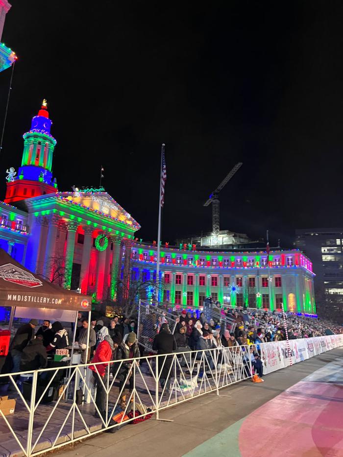 The Denver City and County building lit up with colored lights for Christmas 