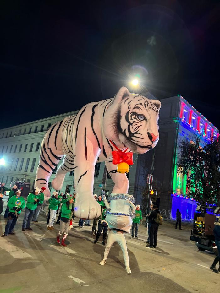 A tiger float, with the costumed toilet standing in front of it. 