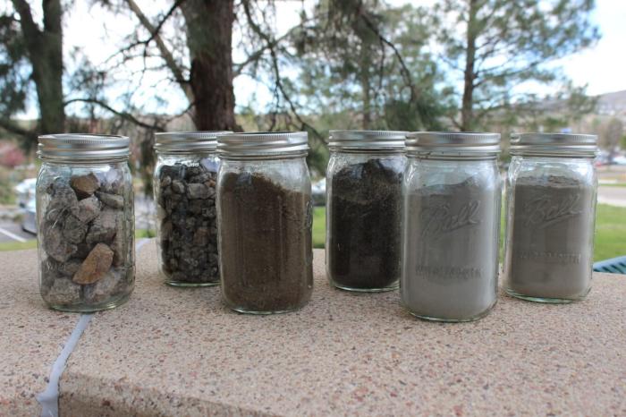 Jars filled with coarse aggregate, medium aggregate, RCC sand, conventional concrete sand, cement and fly ash.