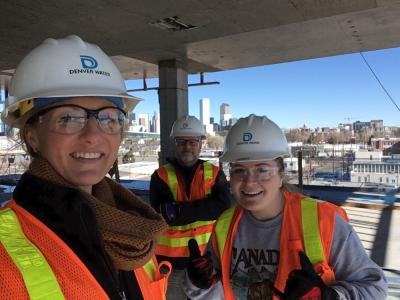 Three people at a construction site