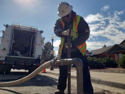 Man works on a water pipe in the street