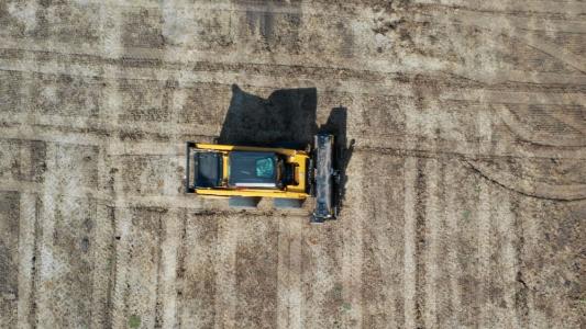 Aerial view of heavy equipment on dirt field