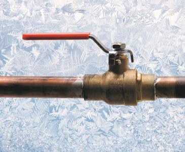 image of a pipe with a valve and red lever that turns the valve on and off.