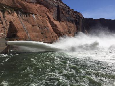 Water sprays from Glen Canyon Dam into the Colorado River