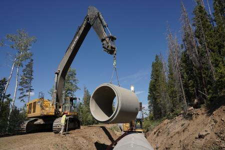 Construction workers place a large section of concrete pipe into the Ranch Creek Canal in Winter Park in August 2020. Photo credit: Denver Water. 