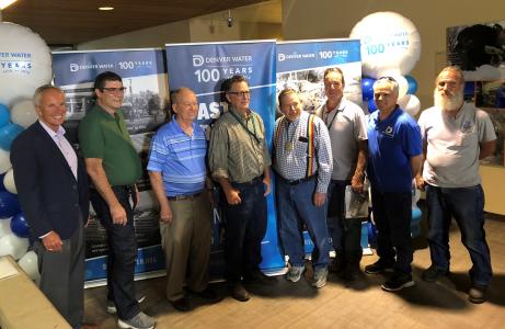 Current and former employees celebrate the opening of a time capsule on Denver Water's 100th anniversary.