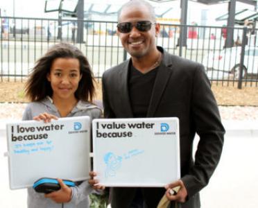 A family stops at the water trailer this summer to enjoy a cup of Denver Water.