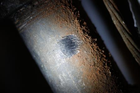 To check your service line for lead, use a key or coin to do a "scratch test" on part of the line inside your home, as NPR shows here. Note the color and whether the metal surface felt hard or soft.