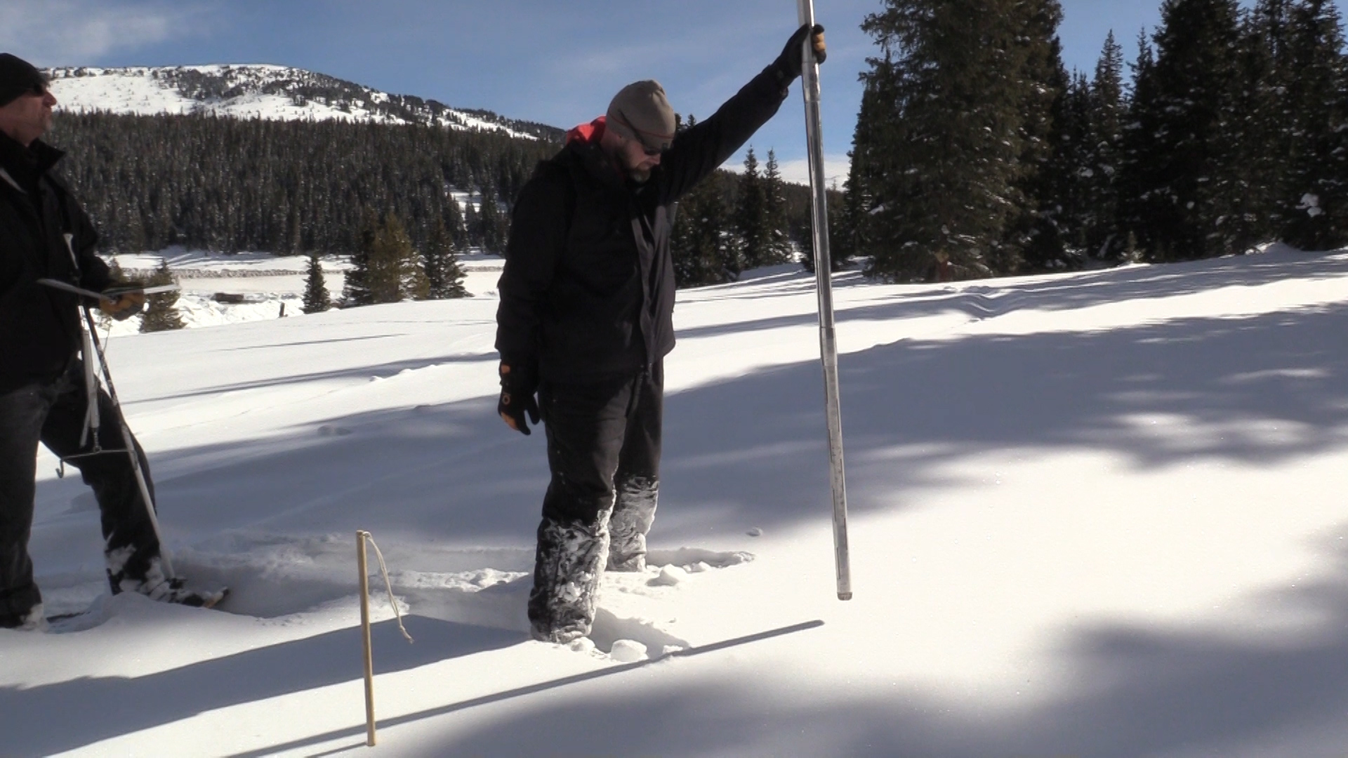 Donald McCreer, mountain snow surveyor, captures a sample of snow using a calibrated snow tube.