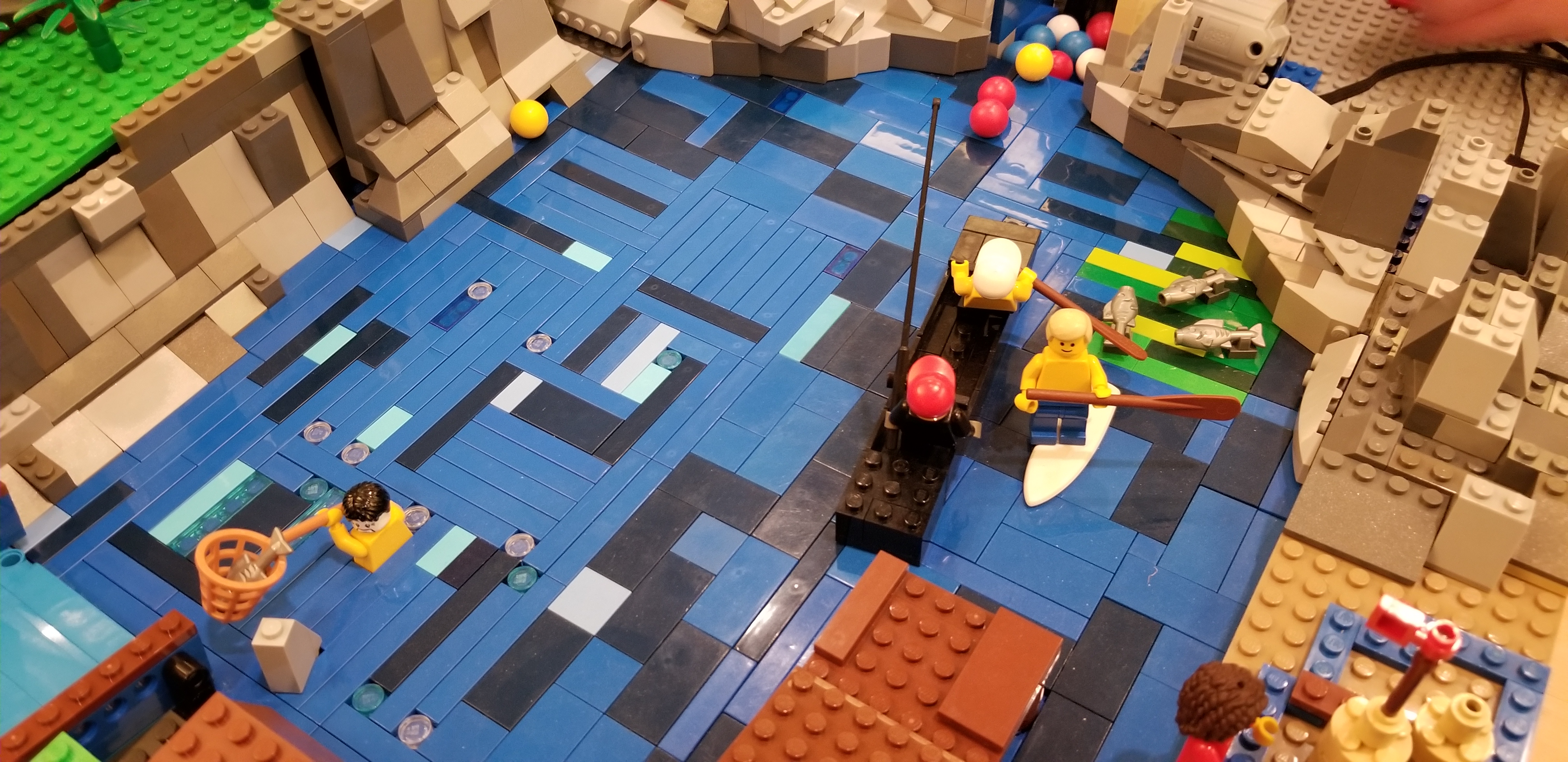 Silas' Lego creation includes a lake of blue legos with endangered fish and people boating.