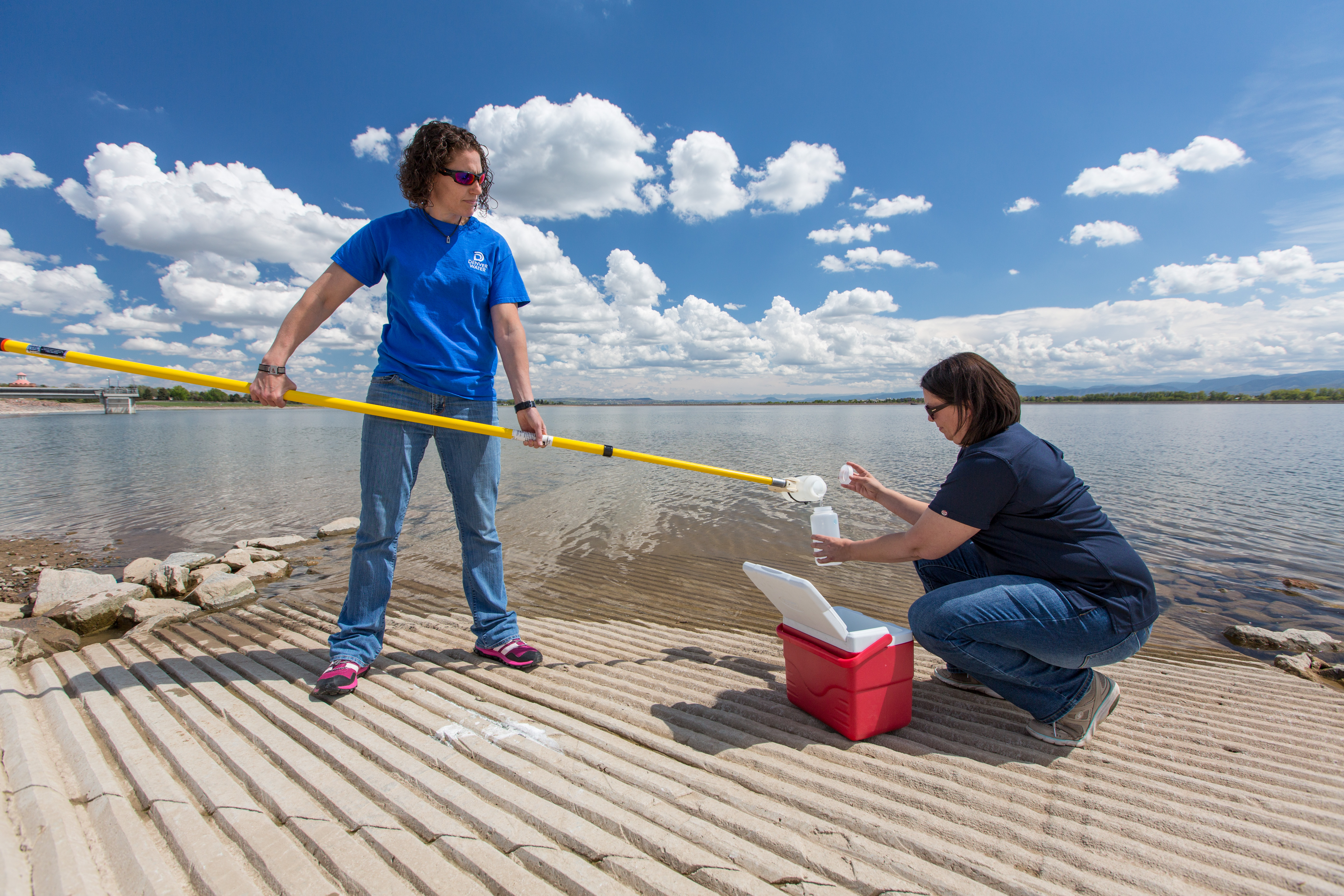 Water quality technicians Nicole Peschel and Aubrey Miller collect samples at the Marston water storage facility.