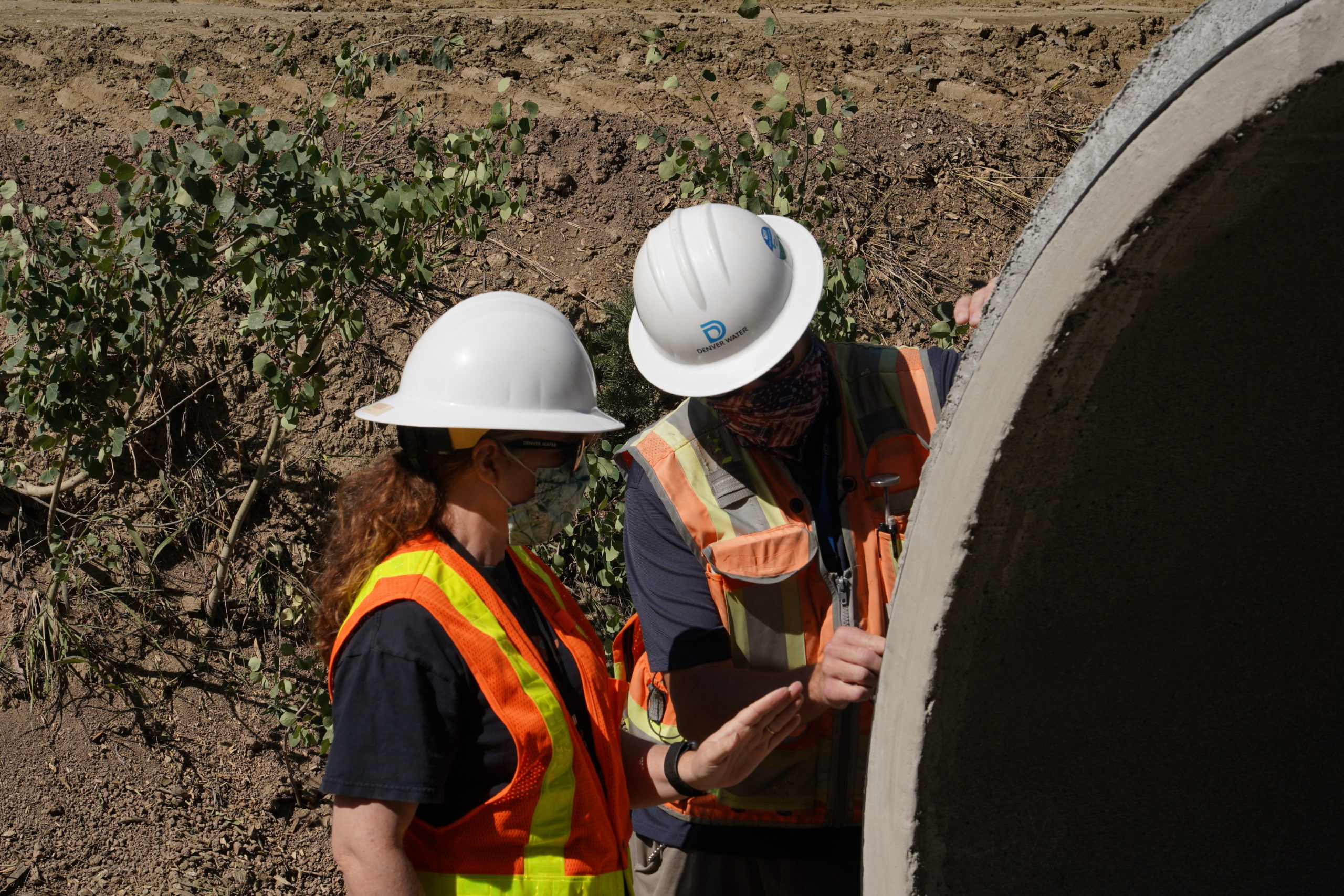 Denver Water project engineer Jessica Barbier (L), and construction project inspector Chris Crumley, check out sections of the new pipe before installation. Photo credit: Denver Water.