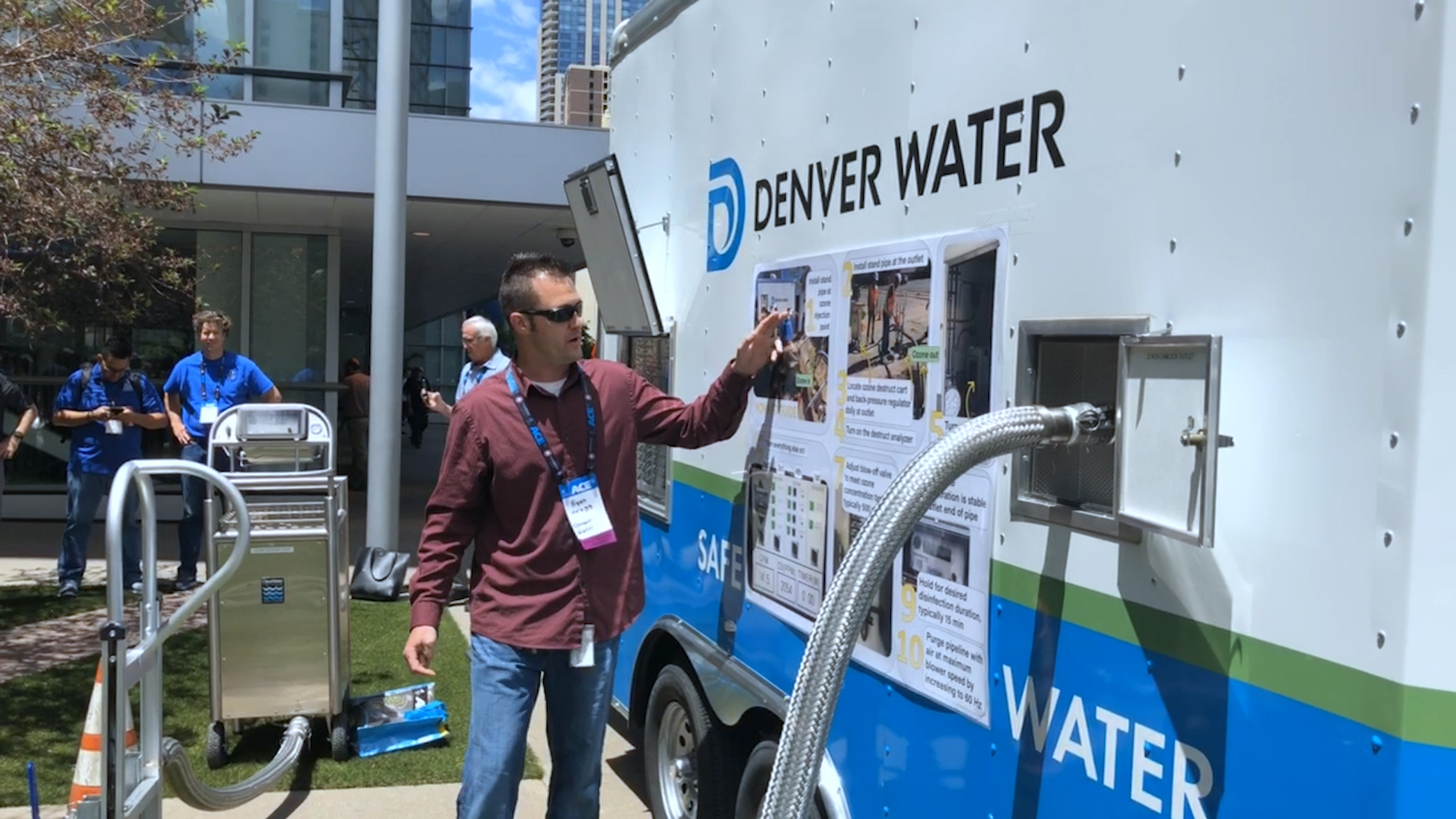 This picture shows a Denver Water employee displaying a water quality device.