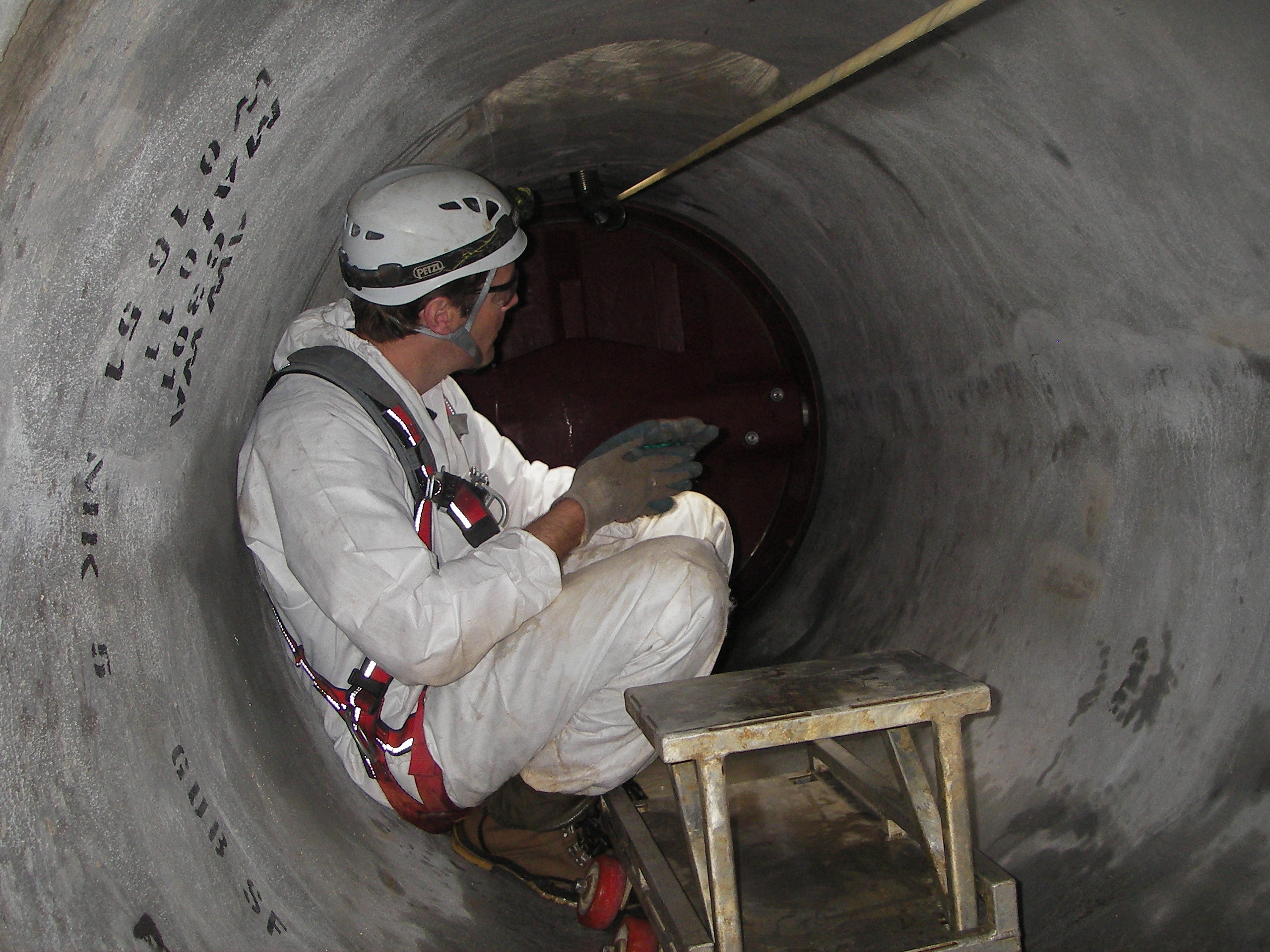 A worker installs the acoustic fiber-optic monitoring cable inside a pipe. File photo credit: Pure Technologies.