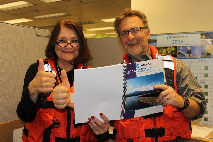 Angie Savard and Norm Carlson pose wearing life jackets.