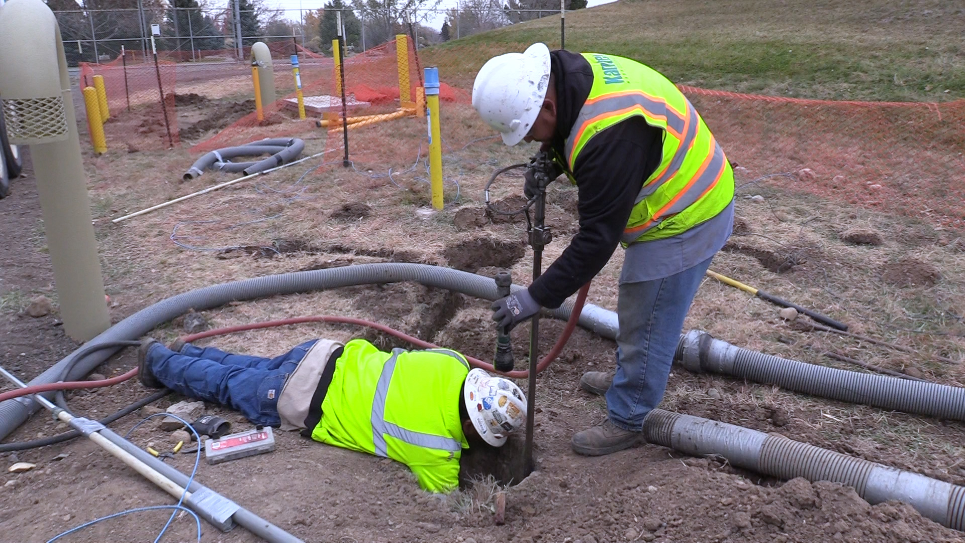 Workers install a cathodic protection test station onto an existing pipe.
