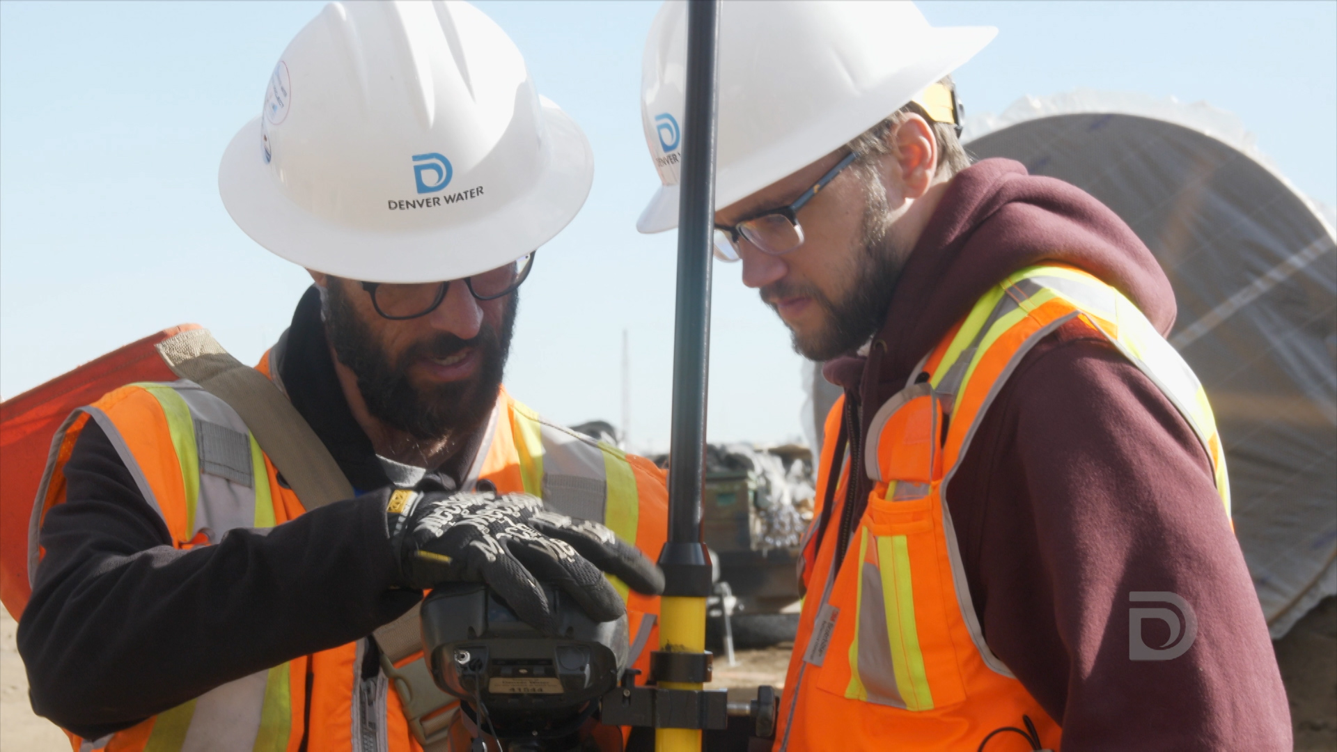 Joe Thompson (left), and Peter Valenti (right), Denver Water survey technicians, locate underground utilities prior to construction.