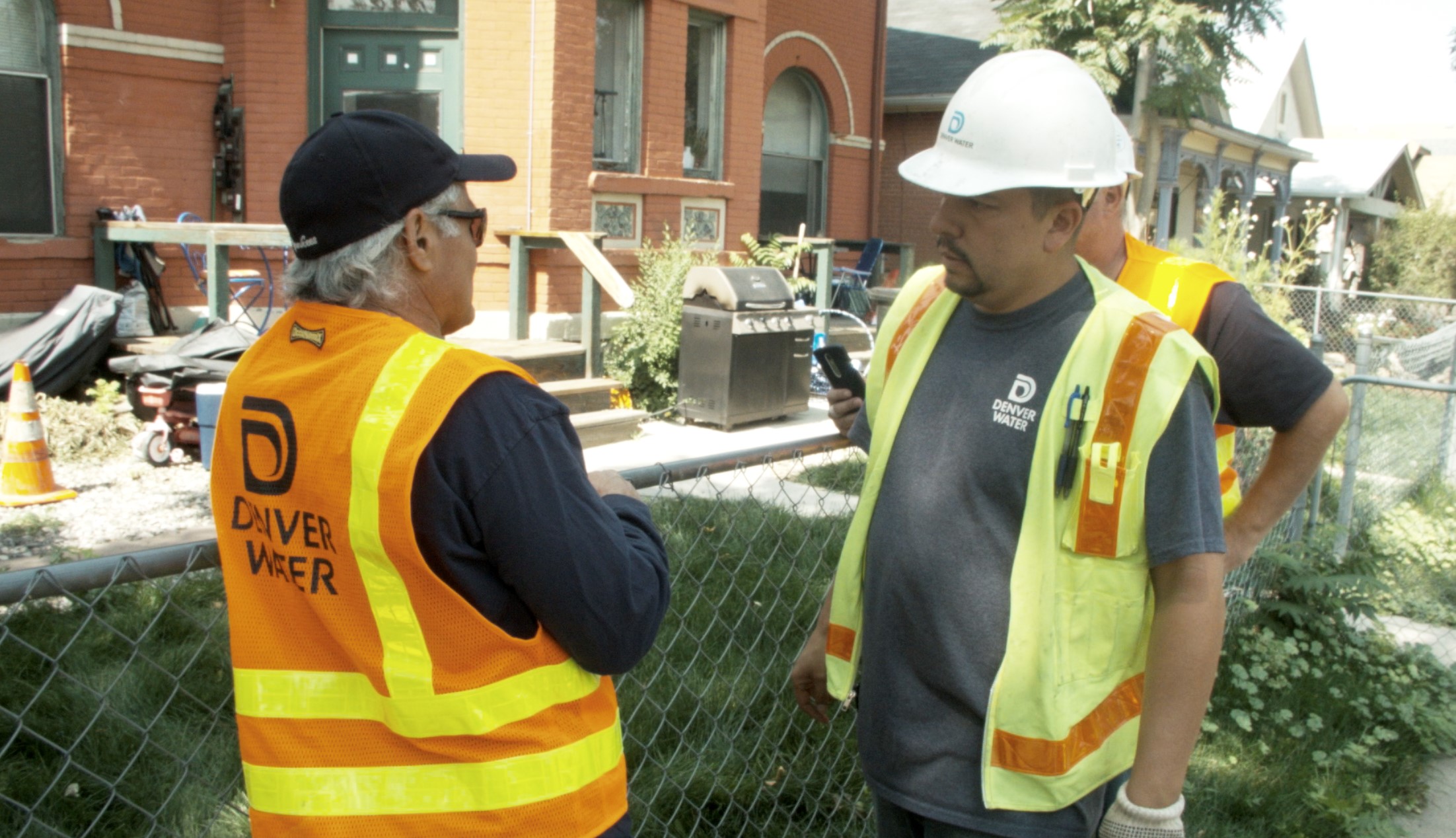 Eddie Torres, left, master plumber at Denver Water, discusses how to fix a leak with Johnny Roybal, water distribution foreman.