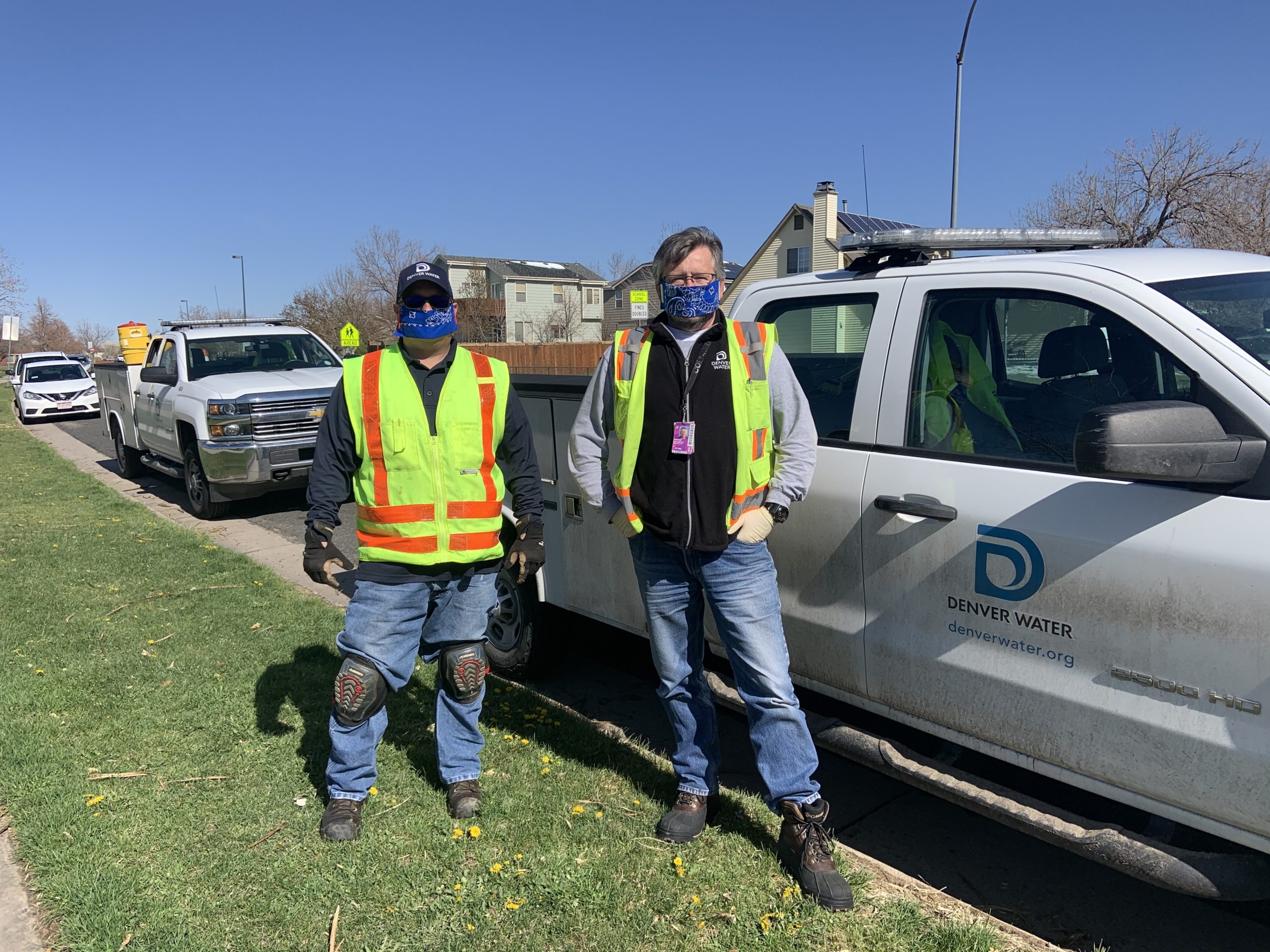Denver Water customer service field workers Jeramy Olmedo and Eddie McCarthy, wear masks on the job. Photo credit: Denver Water.