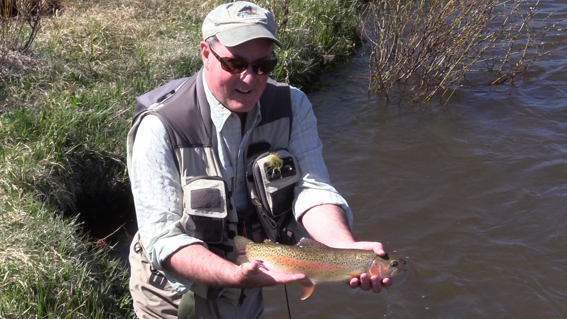 Dave Bennett, water resource strategy director at Denver Water, shows off a rainbow trout caught in the restored section of the Fraser River.