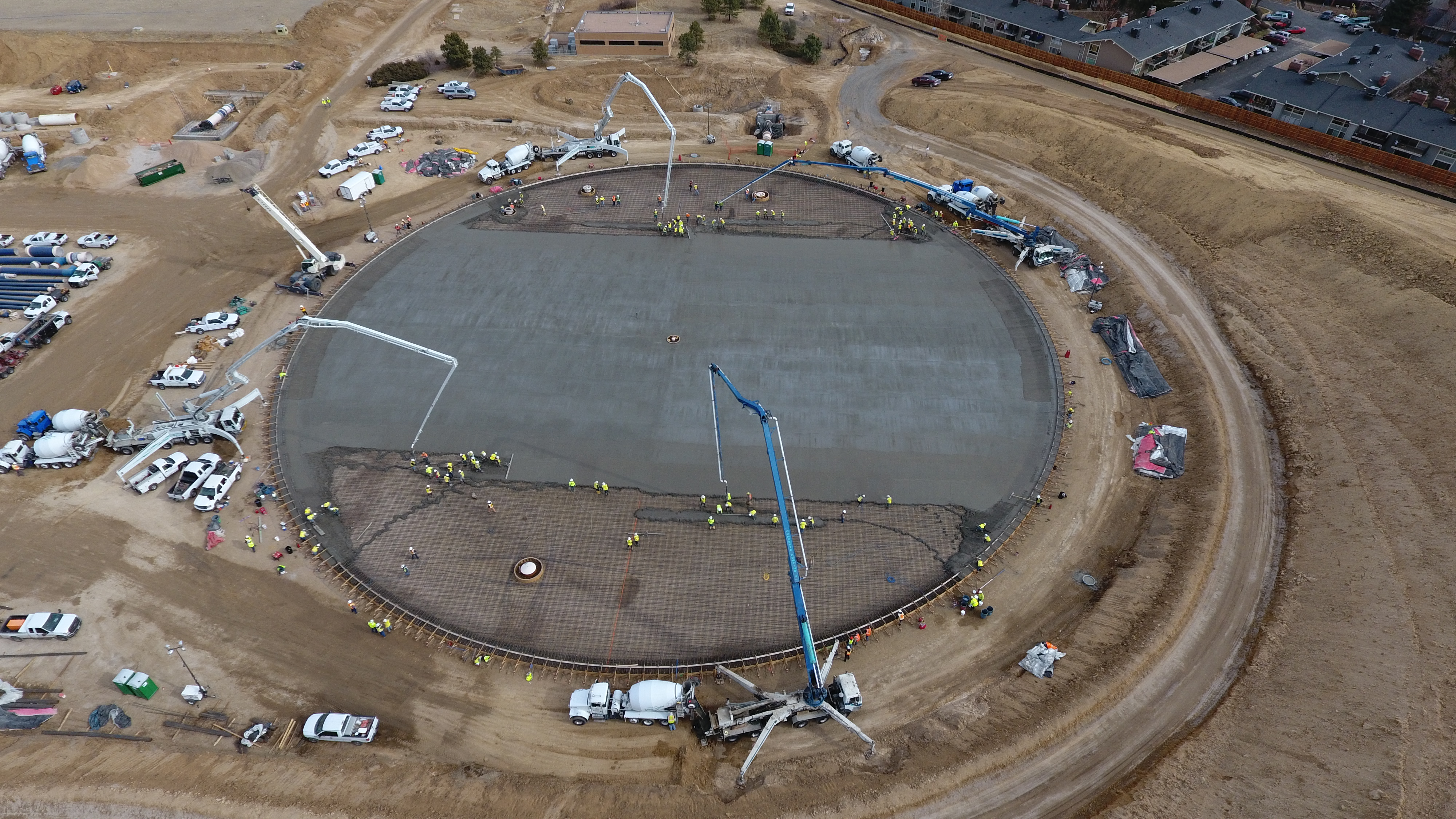 An image, taken by a drone flying above the construction site, shows concrete being poured onto what will be a round storage tank.