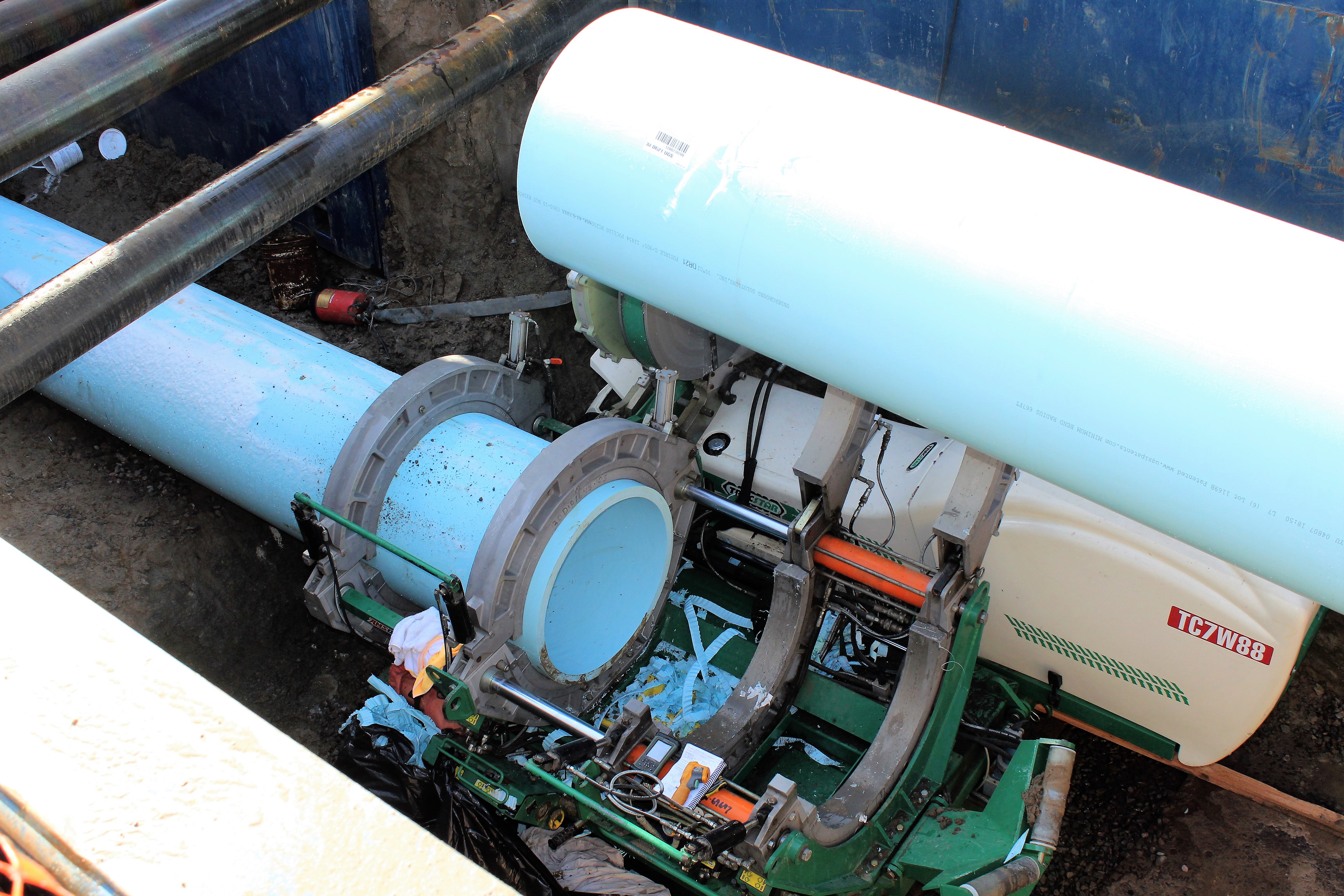 Special machinery thermally fuses two sections of pvc pipe before being pulled through the existing iron pipe. 