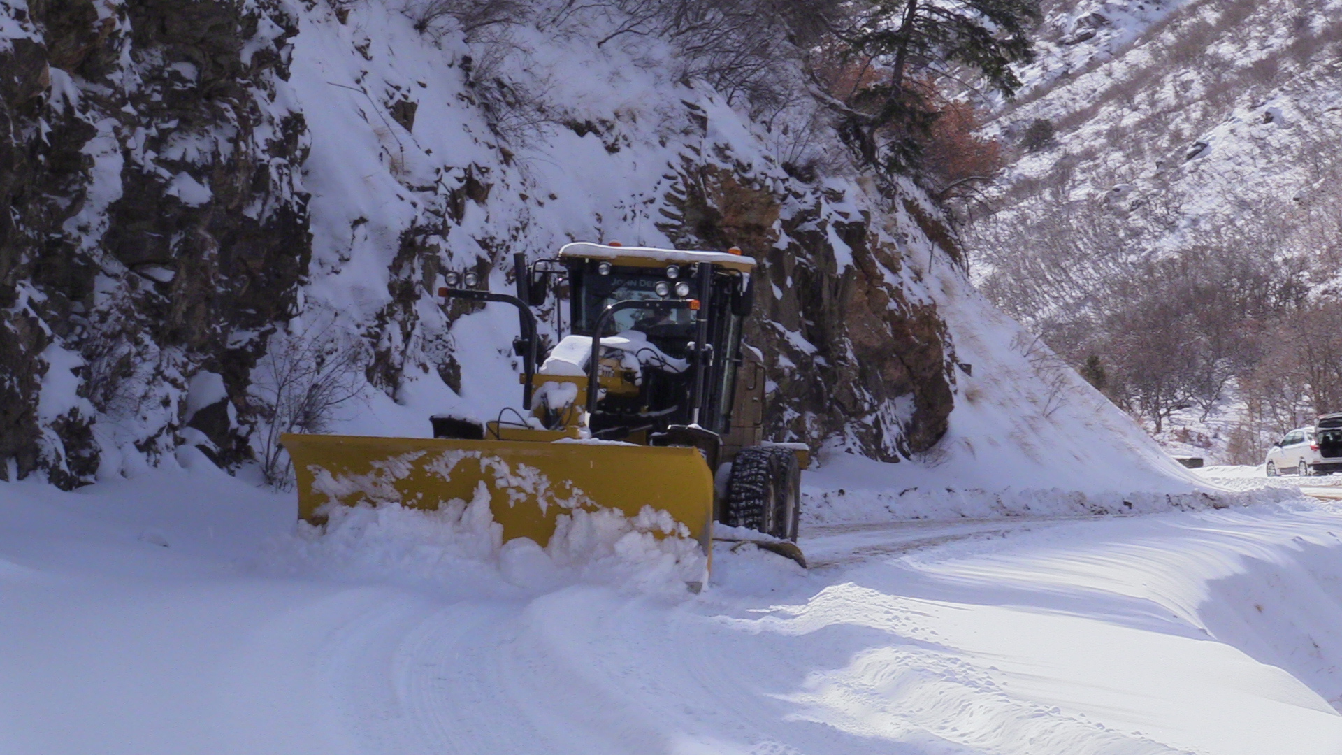 This is a picture of a road grader plowing snow in Waterton Canyon.