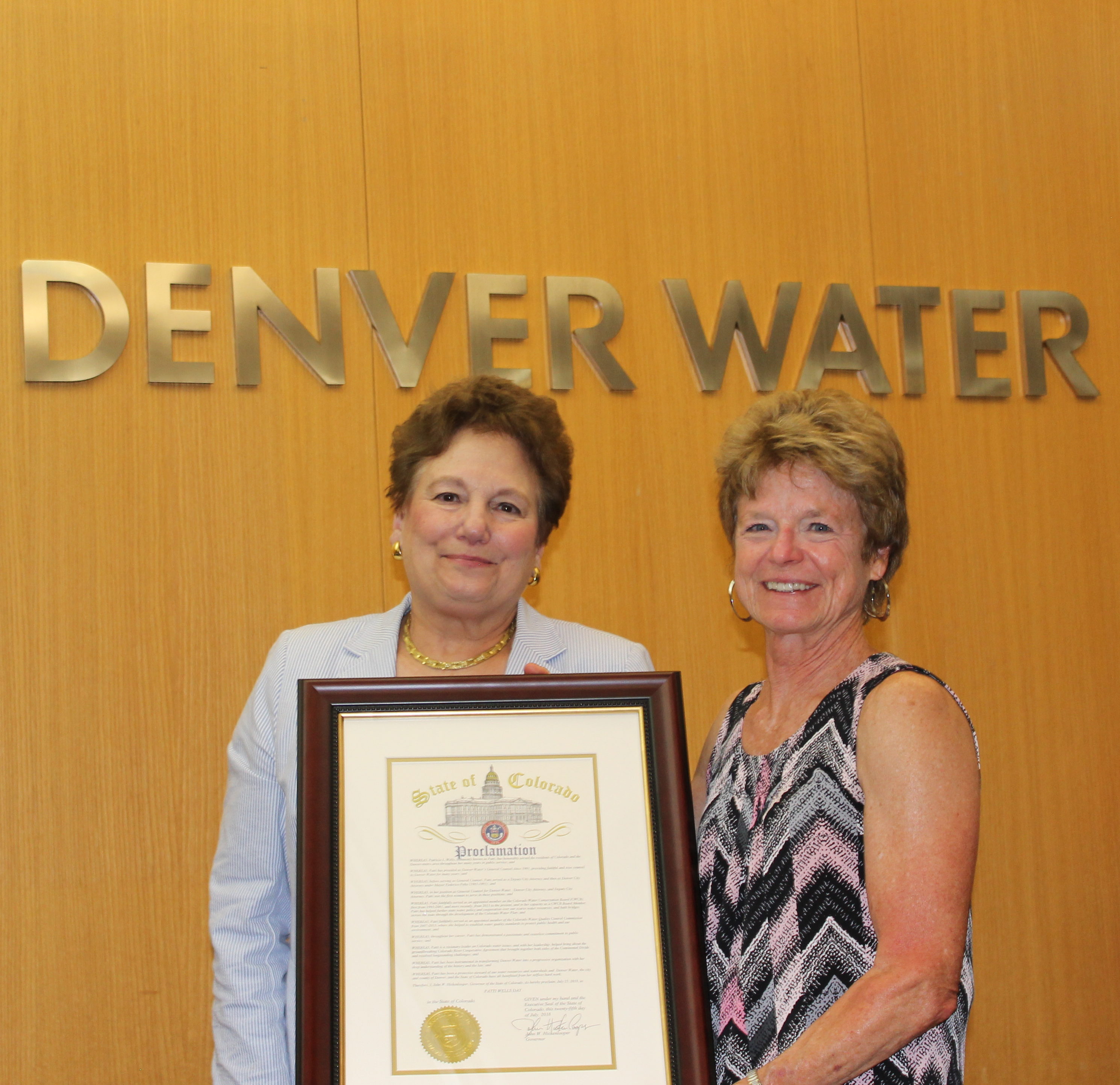 Patti Wells accepts a proclamation from Paula Herzmark, president of the Denver Board of Water Commissioners, that was signed by Gov. John Hickenlooper, declaring July 25, 2018, Patti Wells Day in honor of her contributions statewide.